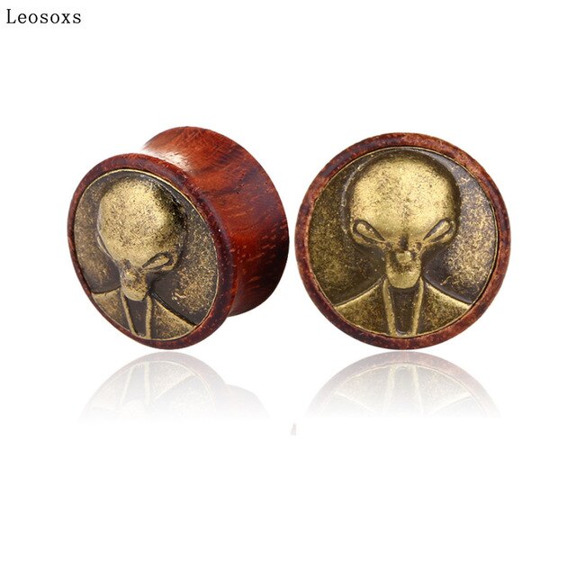 A Pair Of Wooden Expander Earrings With Alien Head Design